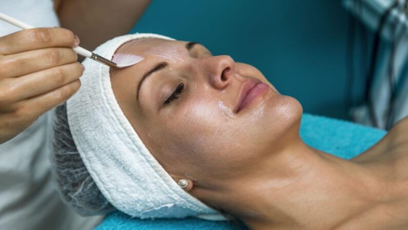 aesthetician applying chemical peel